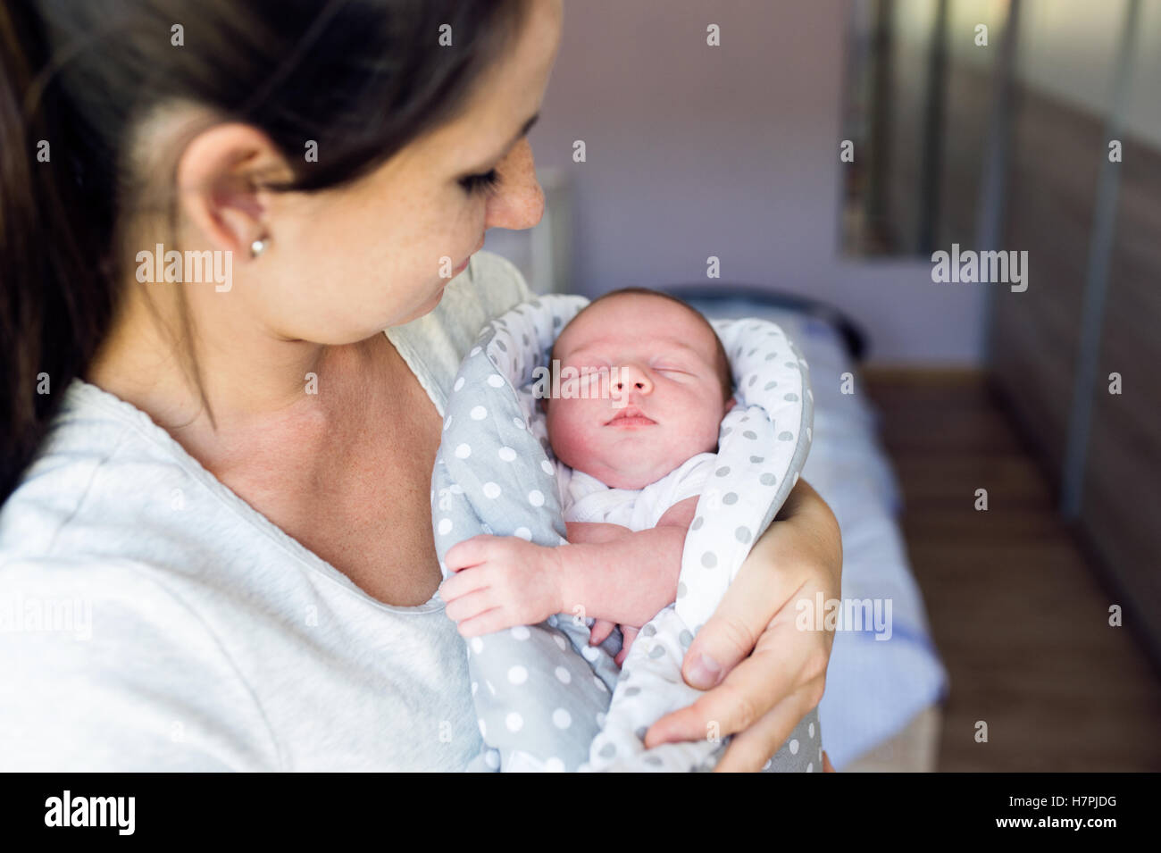 Baby sleeping in mother arms hi-res stock photography and images - Alamy