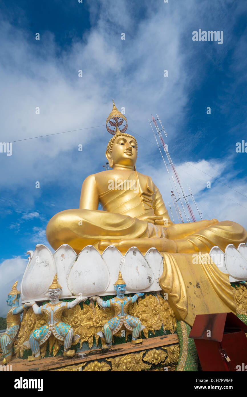 Big Golden Buddha statue against blue sky in Tiger Cave temple ...