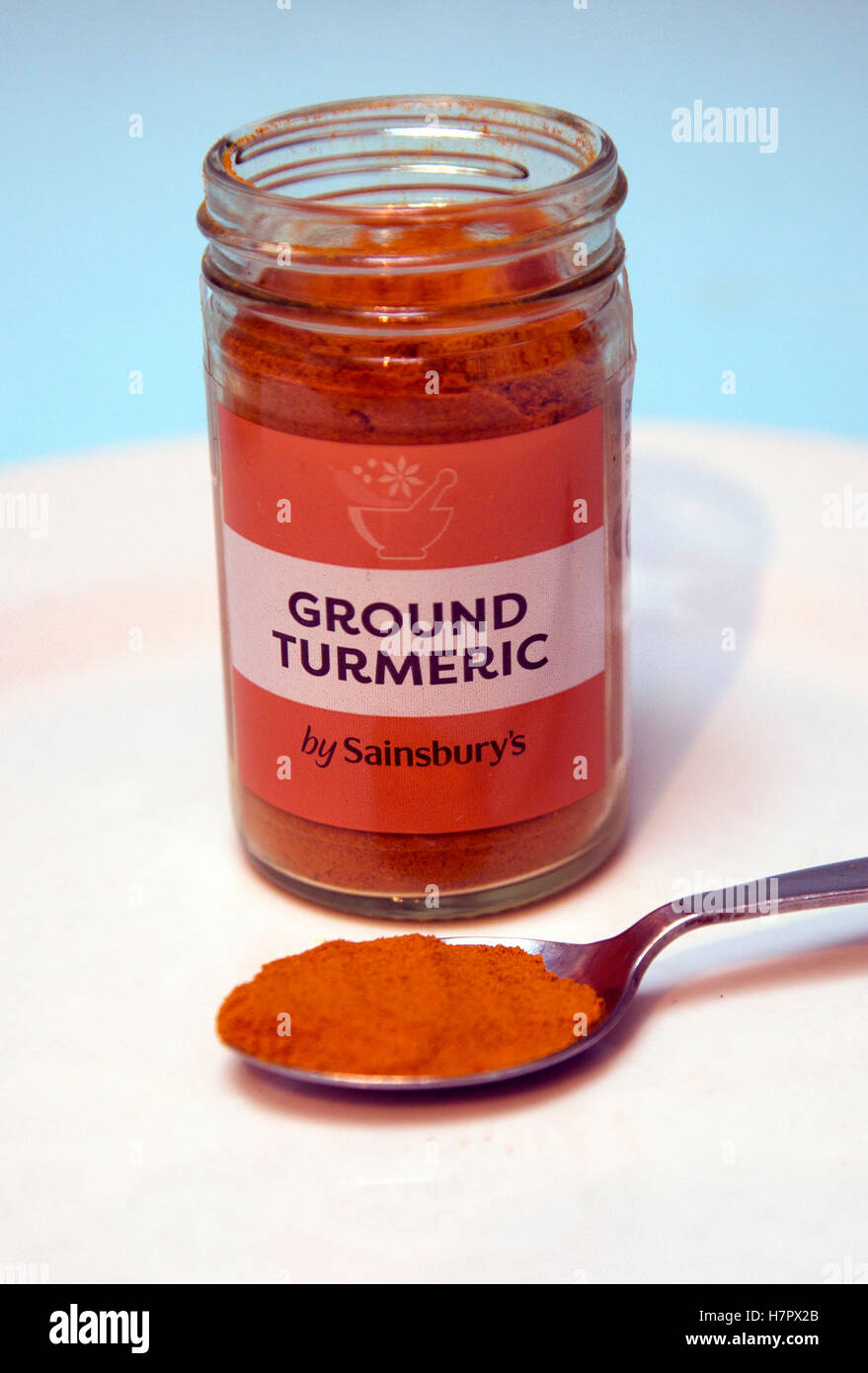 Jar of ground turmeric spice, London Stock Photo