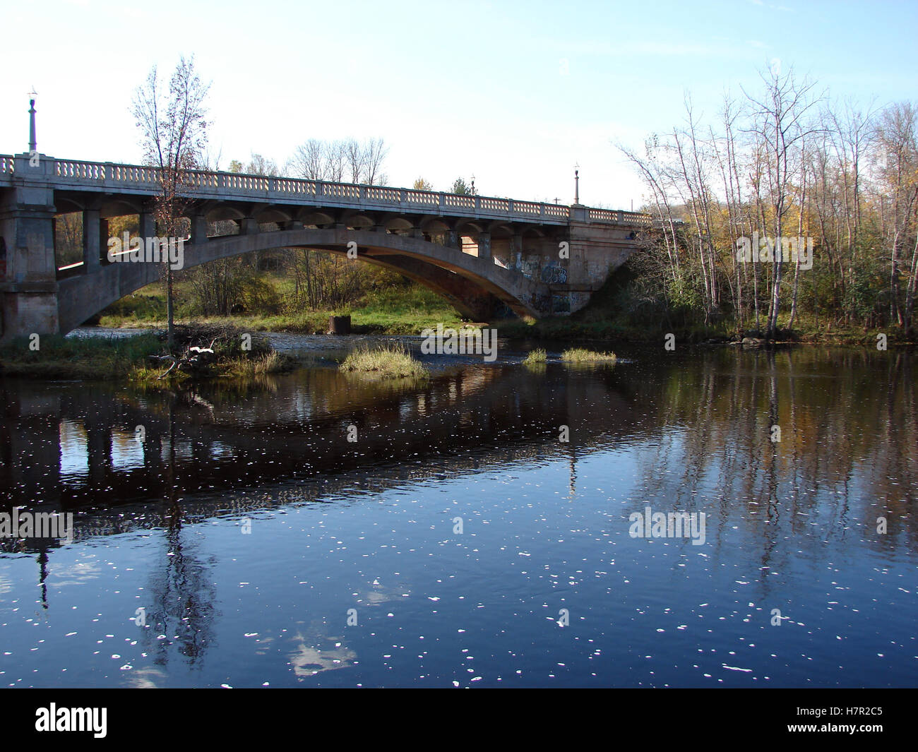 A highway bridge over the Paint River in Crystal Falls, MI Stock Photo