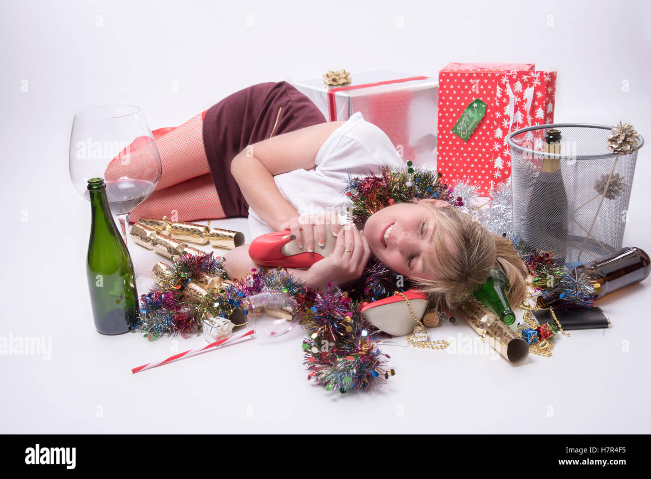 Woman at a party Female party goer sleeping on the floor Stock Photo