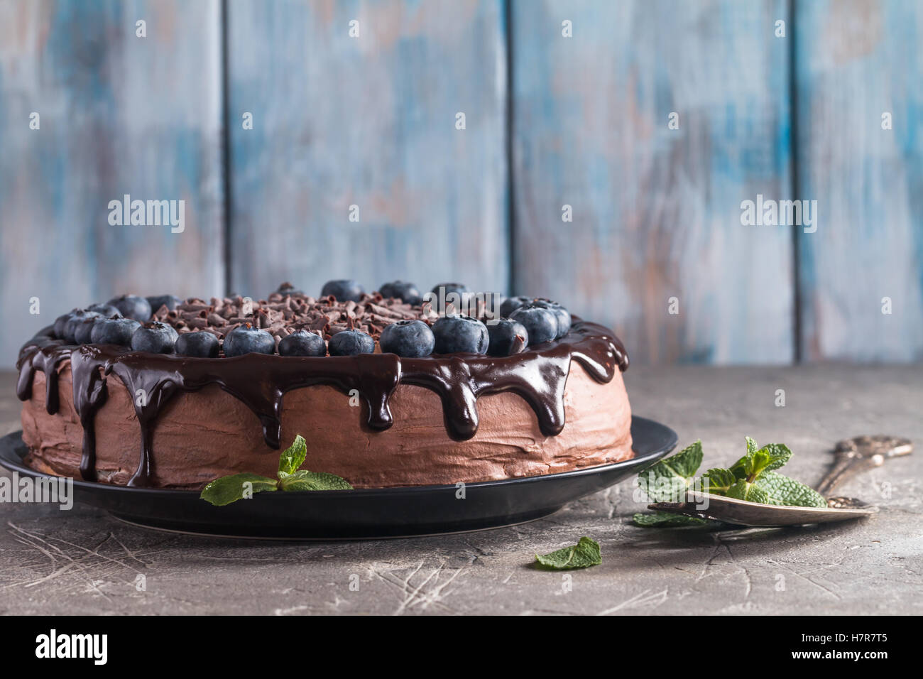 super chocolate cake with chocolate sauce and blueberry Stock Photo - Alamy
