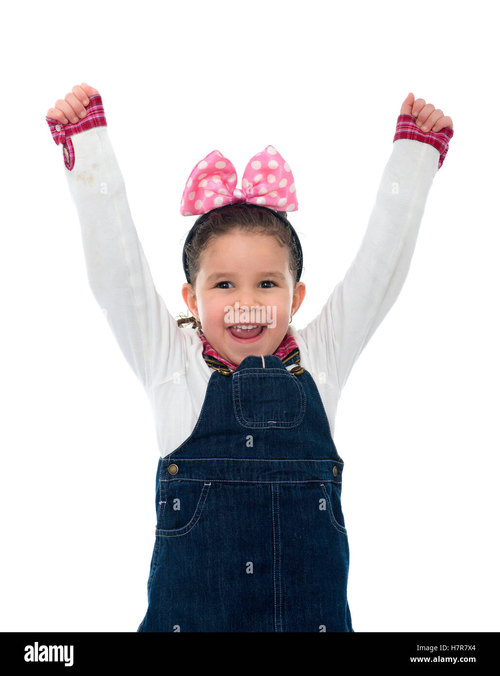 Happy Little Girl Raising Her Arms Up In The Air Isolated on White
