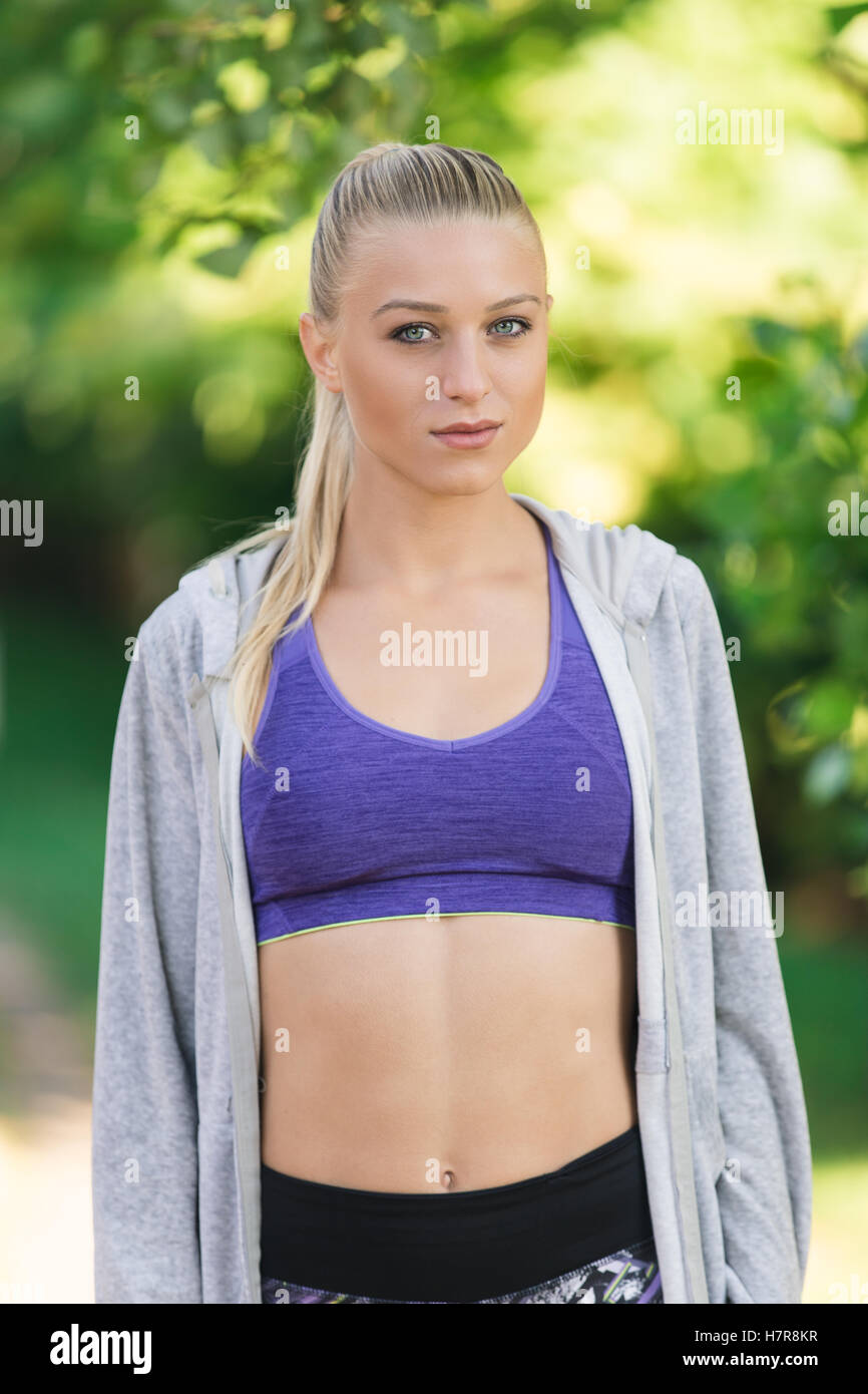Portrait of athletic young woman resting after jogging Stock Photo - Alamy