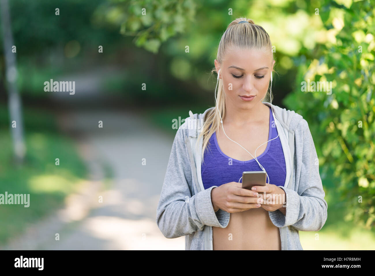 Portrait of athletic young woman resting after jogging Stock Photo - Alamy
