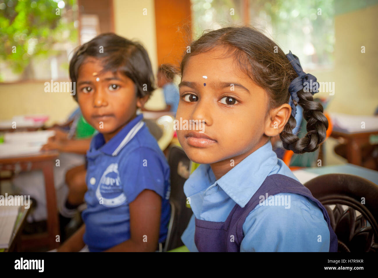 Young primary or elementary school children sitting at their desks in a classroom, The Hope Foundation School, India Stock Photo
