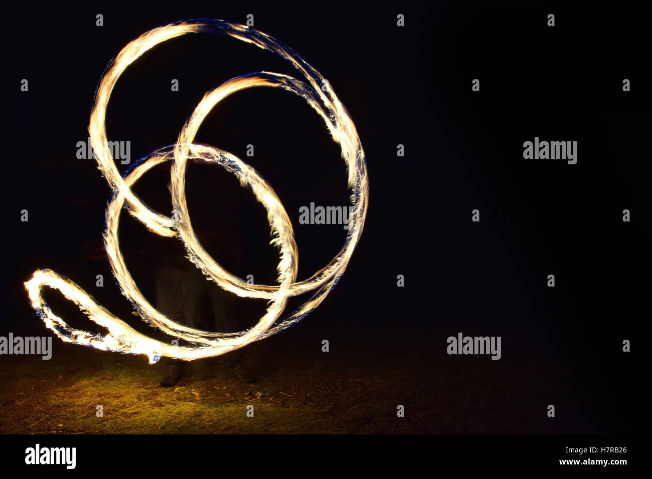 Spinning fire poi Stock Photo