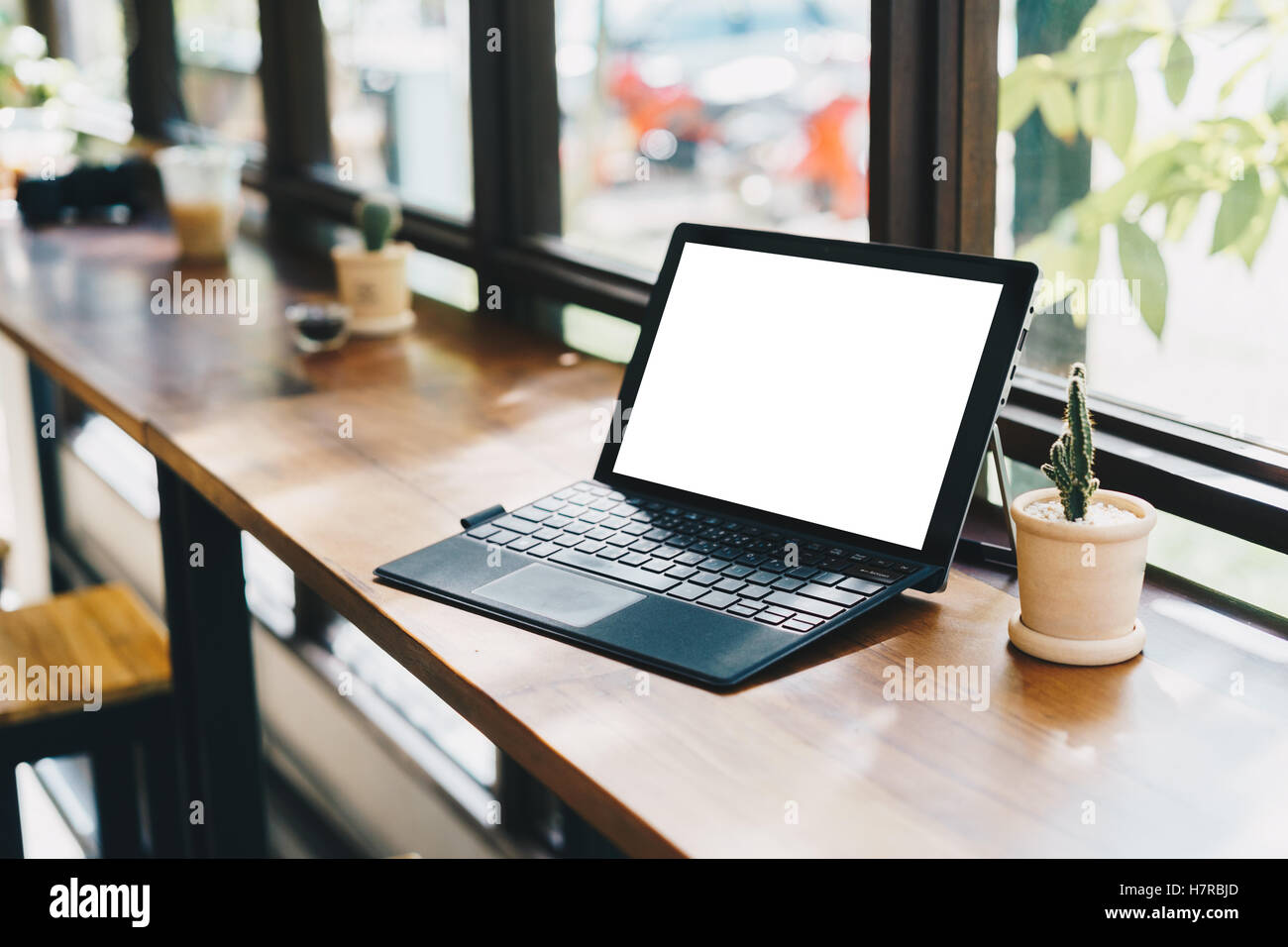 Laptop with blank screen on table,Responsive design mockup,Corporate identity mock up on desk with laptop computer,smart phone,c Stock Photo