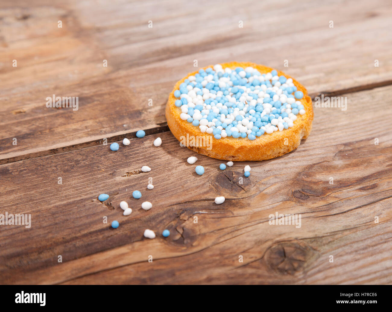 Traditional Dutch birth celebration biscuit with blue muisjes on wooden background Stock Photo