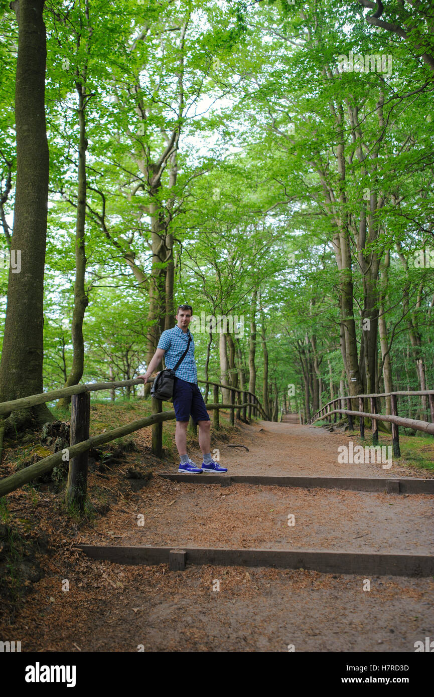 Young man on a walk in the forest Stock Photo - Alamy