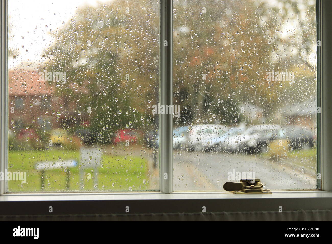 British English weather rainy autumn day viewed through Georgian sash window in market town. Stock Photo