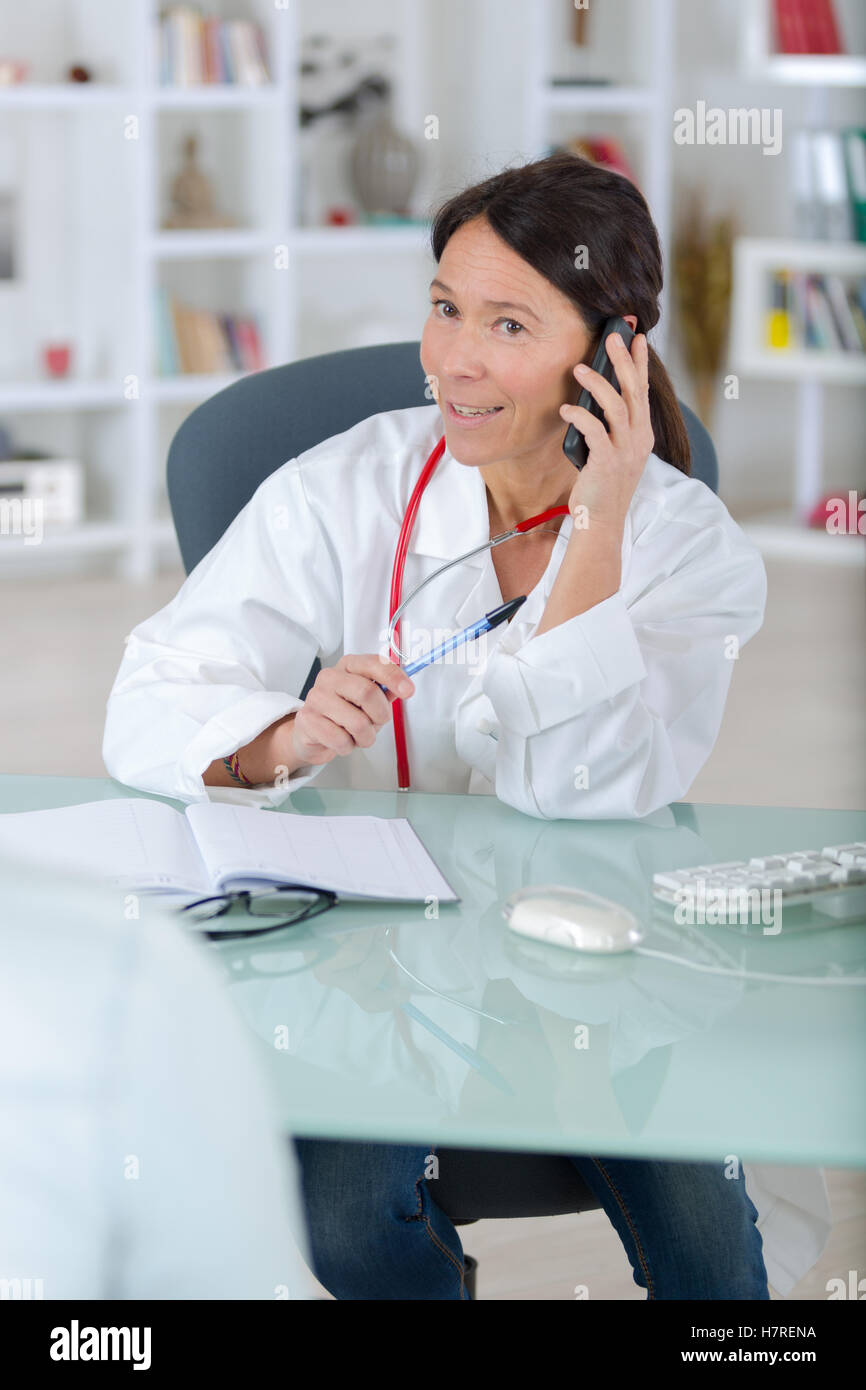 doctor on the phone calling analyzes centre with patient Stock Photo ...
