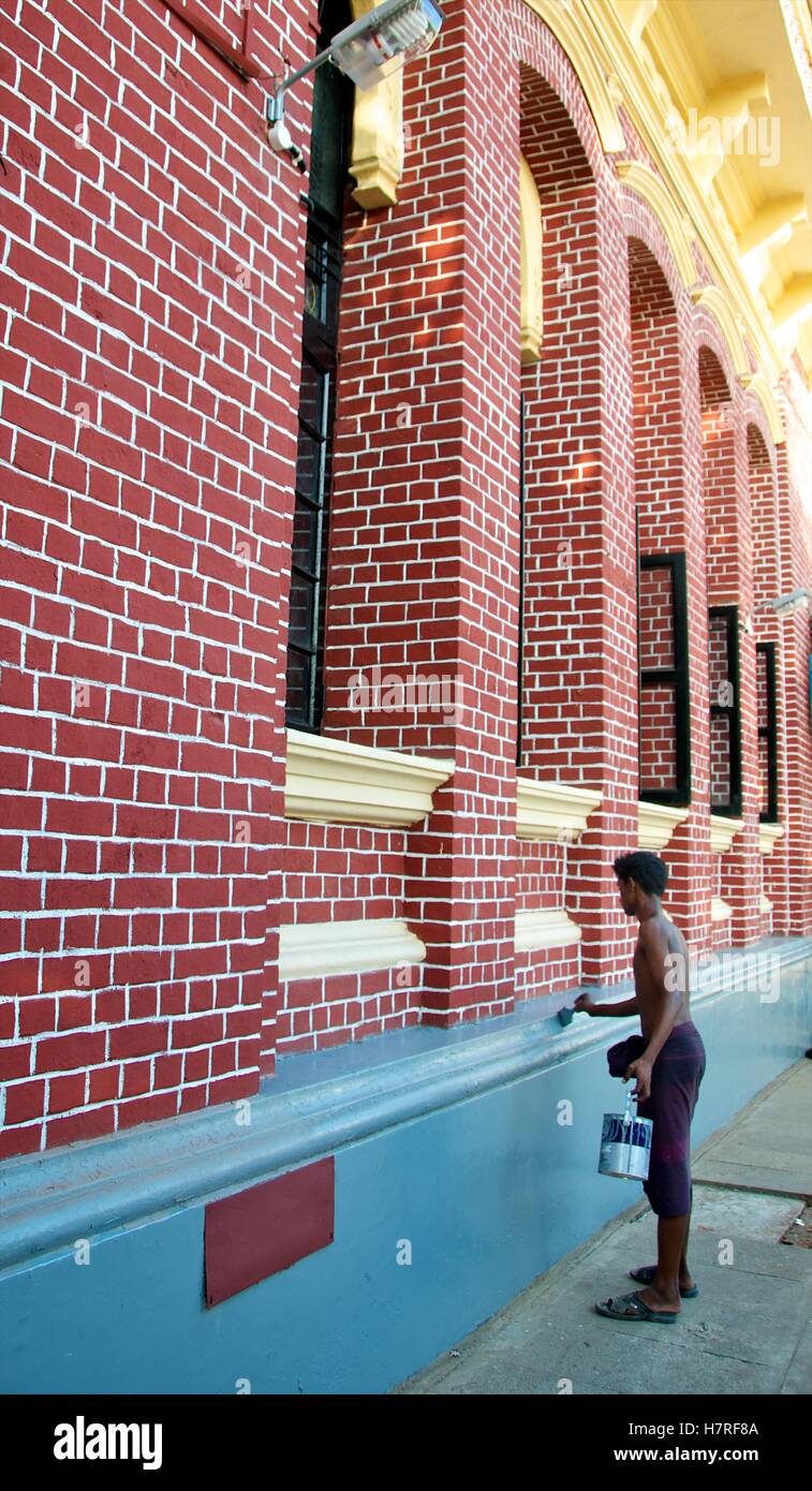 Yangon, Myanmar - 11 November 2014. Worker painting the exterior of the Custom House. Stock Photo
