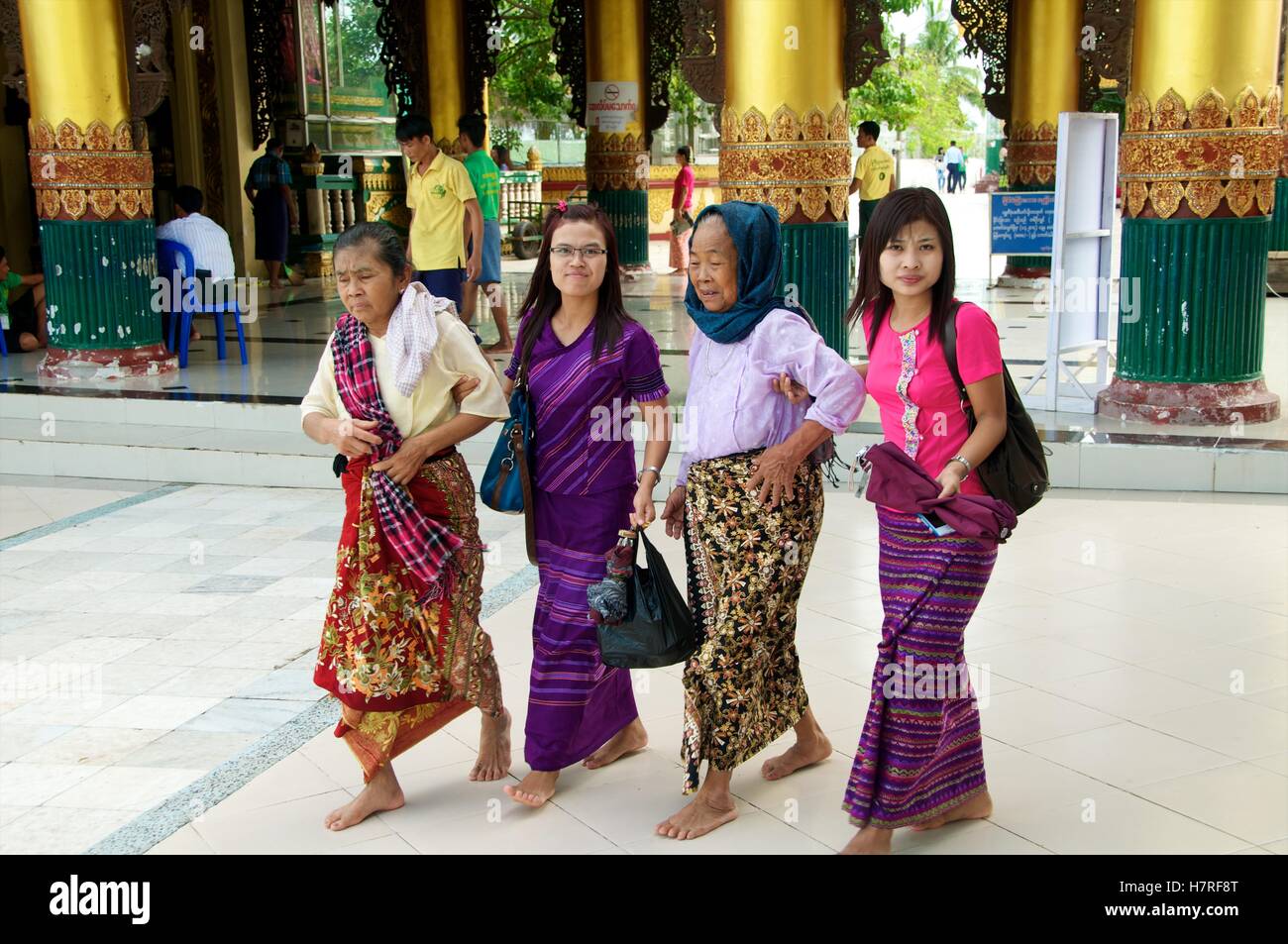 Yangon, Myanmar - 11 November 2014. Young helping old visitrs to the Shwedagon Stock Photo