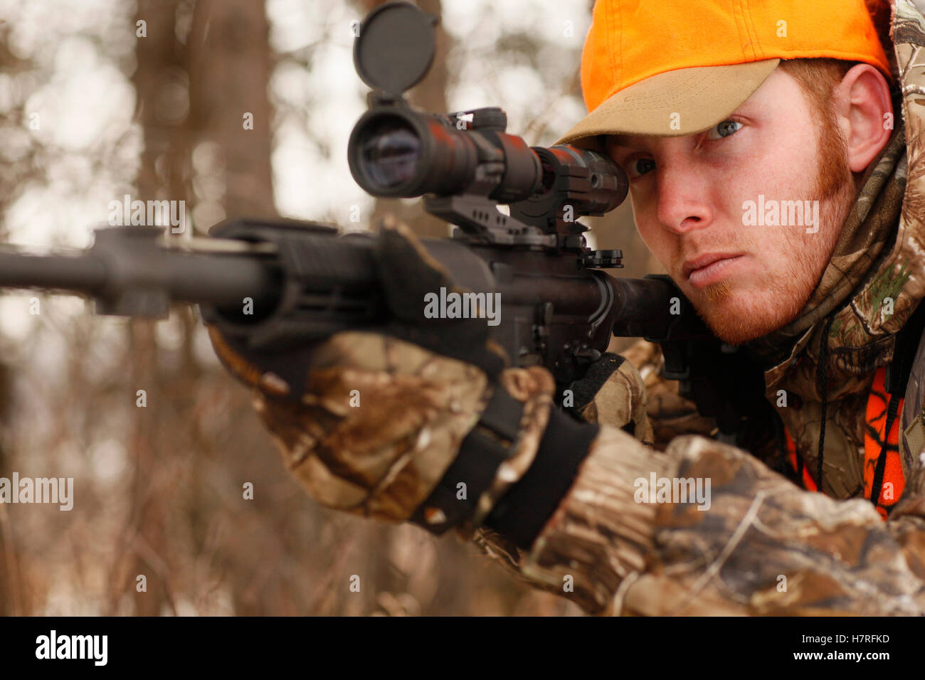 Hunter Aims Rifle While Deer Hunting Stock Photo