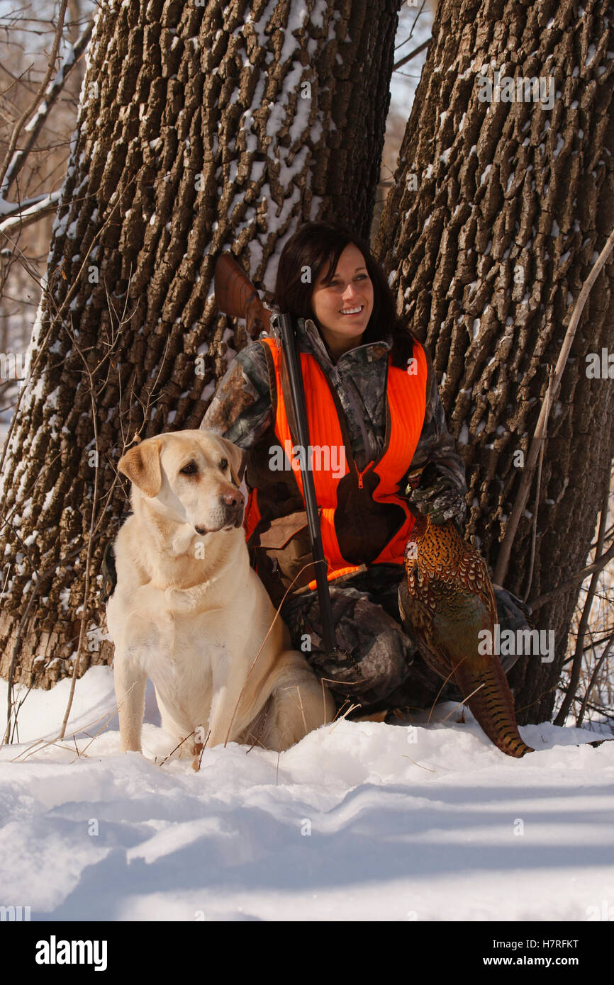 Female Pheasant Hunter In Winter With Yellow Lab Stock Photo Alamy
