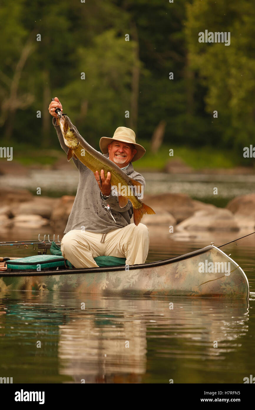 Bass Fishermen In Canoe In A River Stock Photo