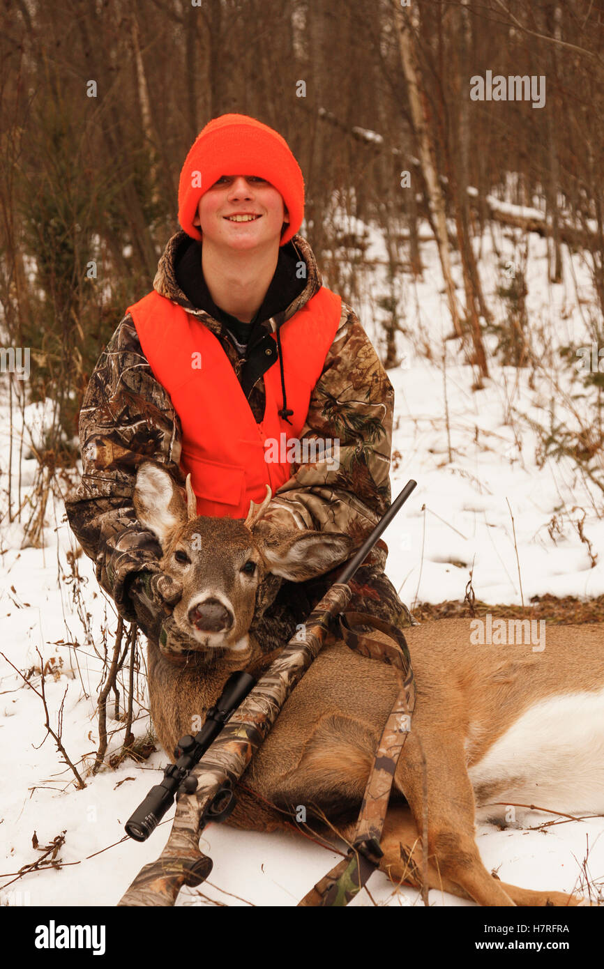 Young Hunter With Dead Whitetail And Rifle Stock Photo