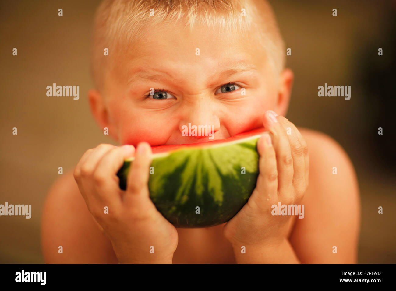 Boy Eating A Slice Of Watermelon Stock Photo