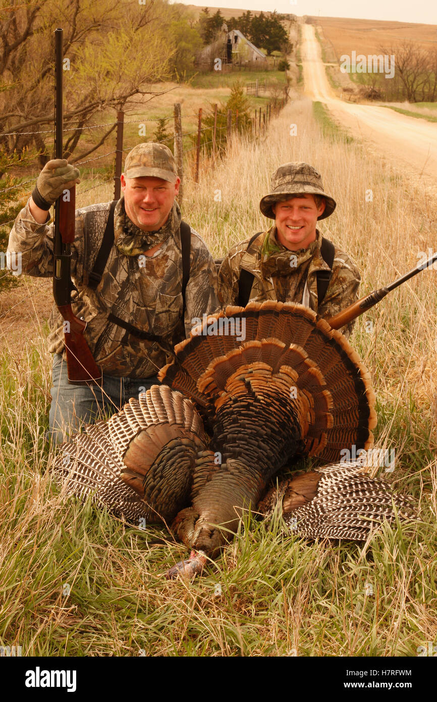 Two Turkey Hunters Walking Carrying Dead Turkeys Stock Photo - Alamy
