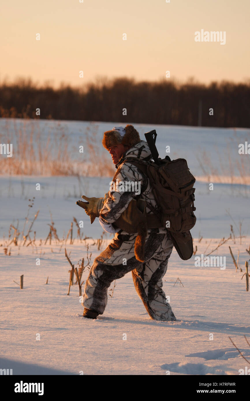 Varmint Hunter Walking Through Snow Stock Photo