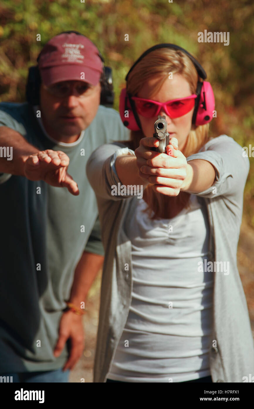 Woman Getting Instructed At Shooting Range With Handgun Stock Photo