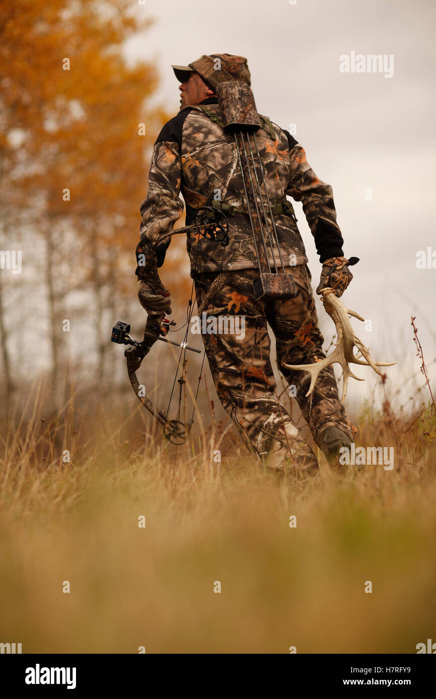 Bowhunter Carrying Rattling Antlers Stock Photo