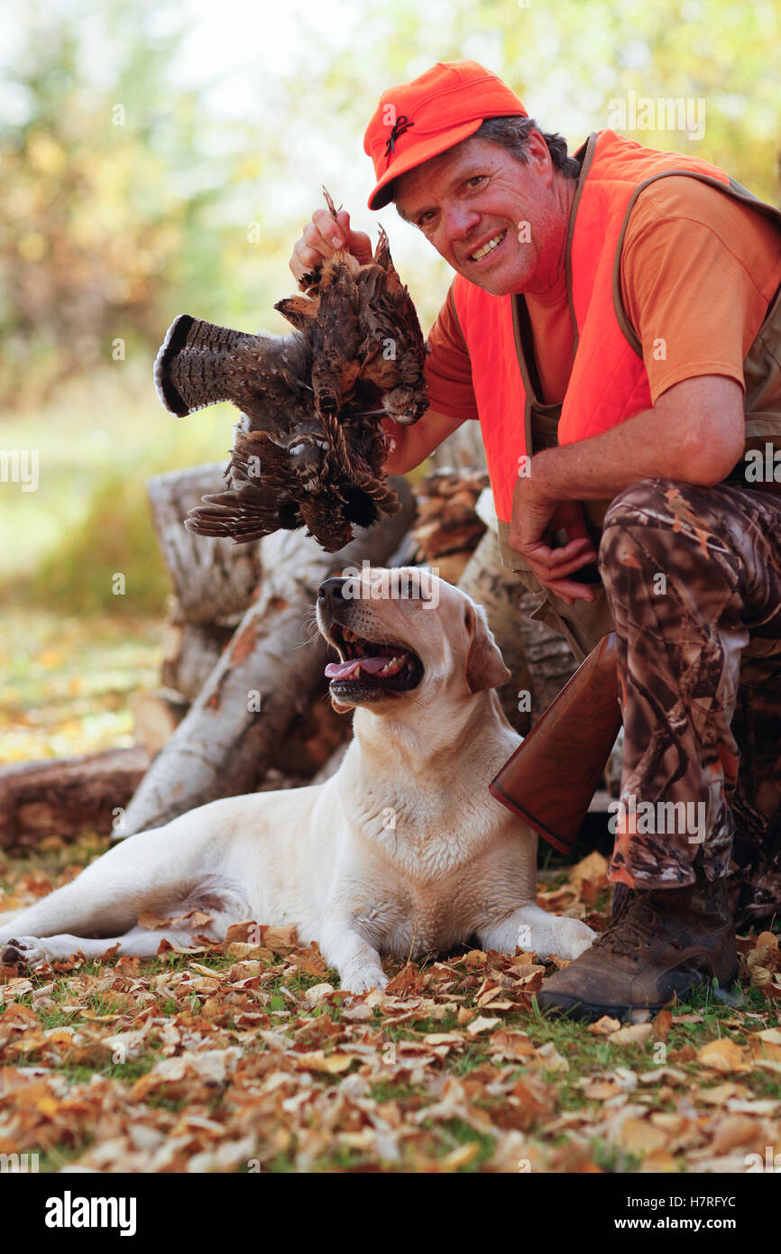 Grouse Hunter After Hunt With Yellow Lab Stock Photo