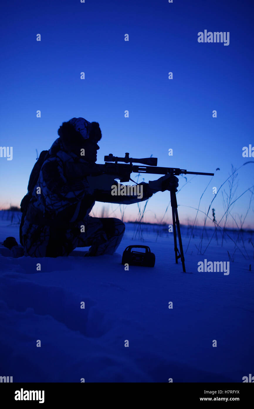 Silhouette Of Cold Weather Varmint Hunter Stock Photo