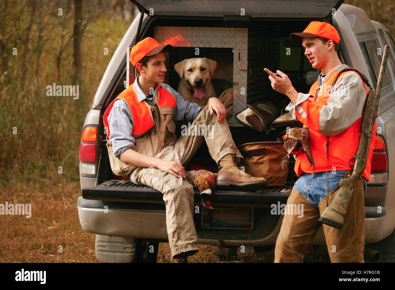 Young Hunters With Dog On Tailgate Stock Photo