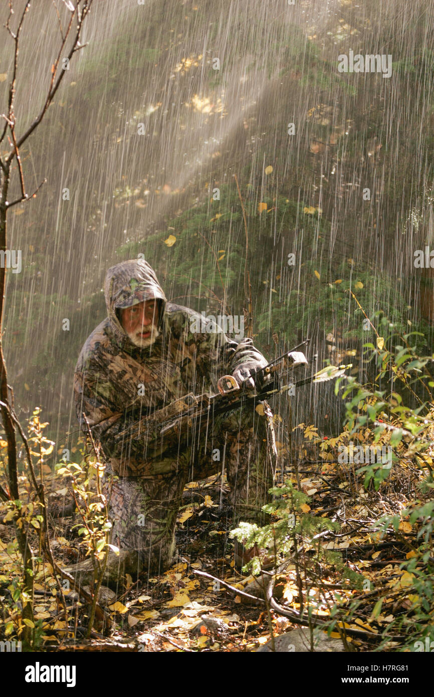 Extreme Big Game Bowhunter In Mountains Stock Photo