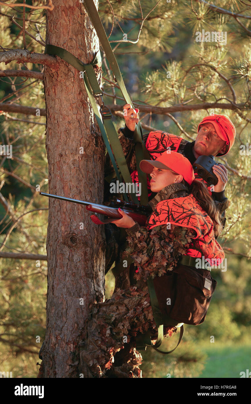 Female Hunter Climbs Into Tree Stand While Deer Hunting Stock Photo Alamy