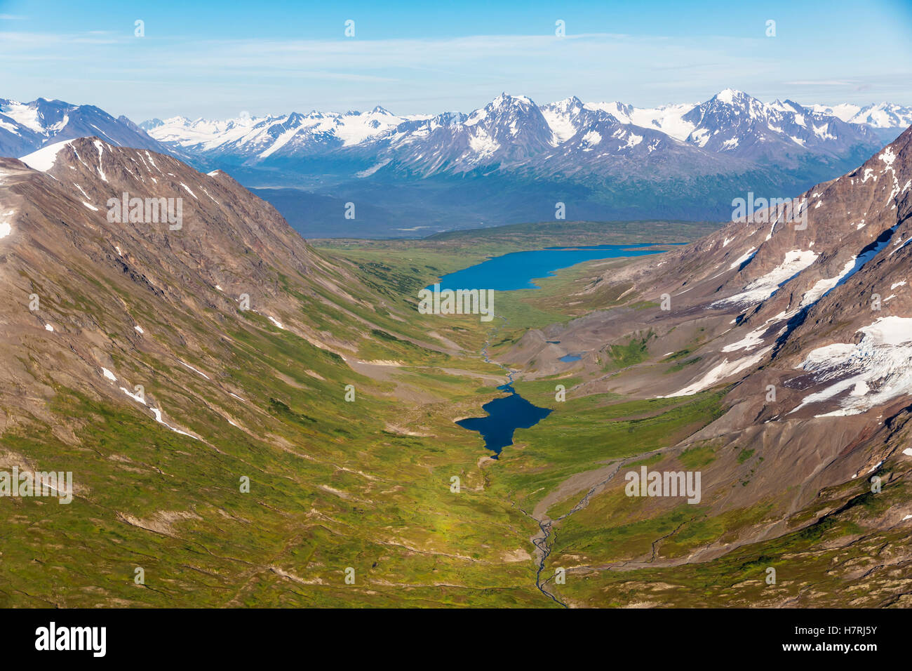 Aerial view of spring snow melting off the Kenai mountains on a clear