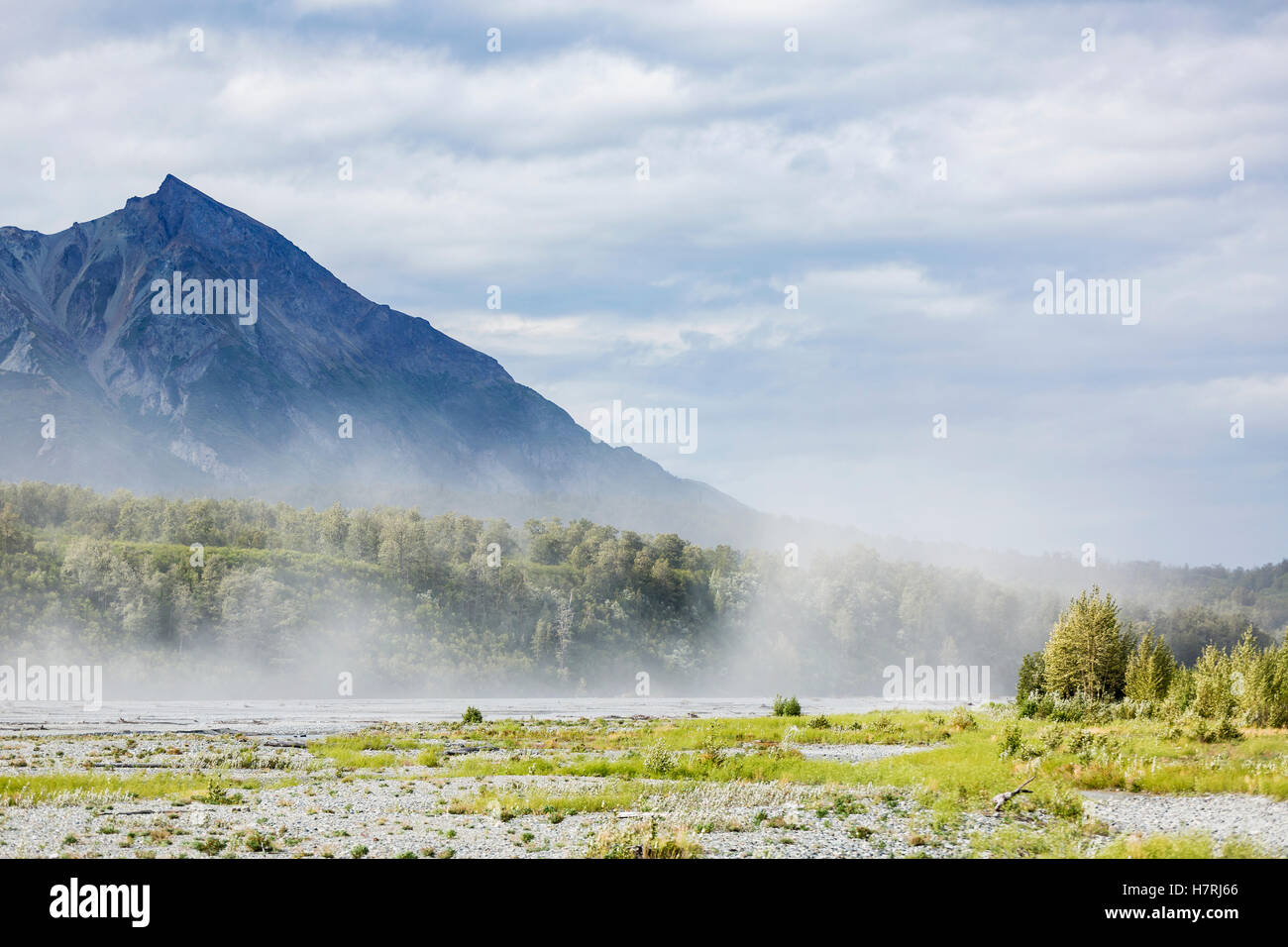 River silt being blown about Matanuska River bed on a windy and cloudy day, King Mountain in the background, south-central Alaska in summertime Stock Photo