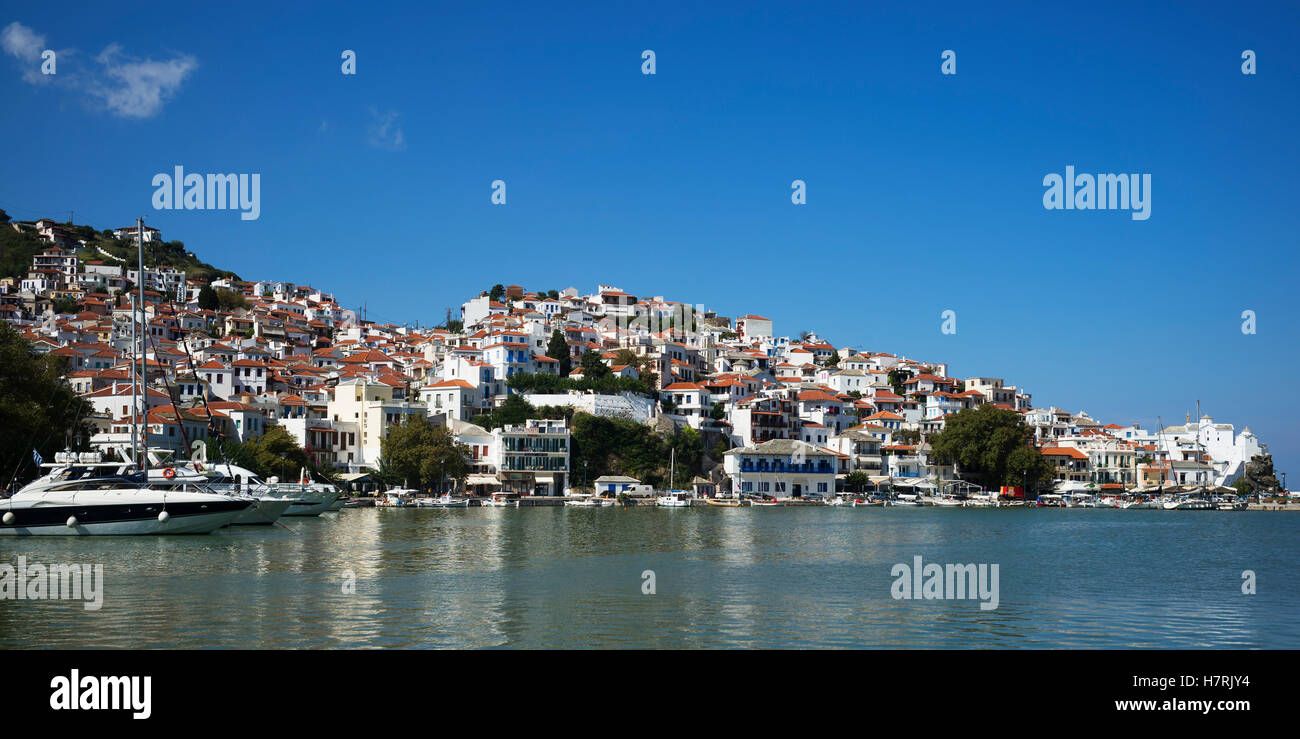 Houses in a village and boats in a harbour of a greek island; Panormos, Thessalia Sterea Ellada, Greece Stock Photo