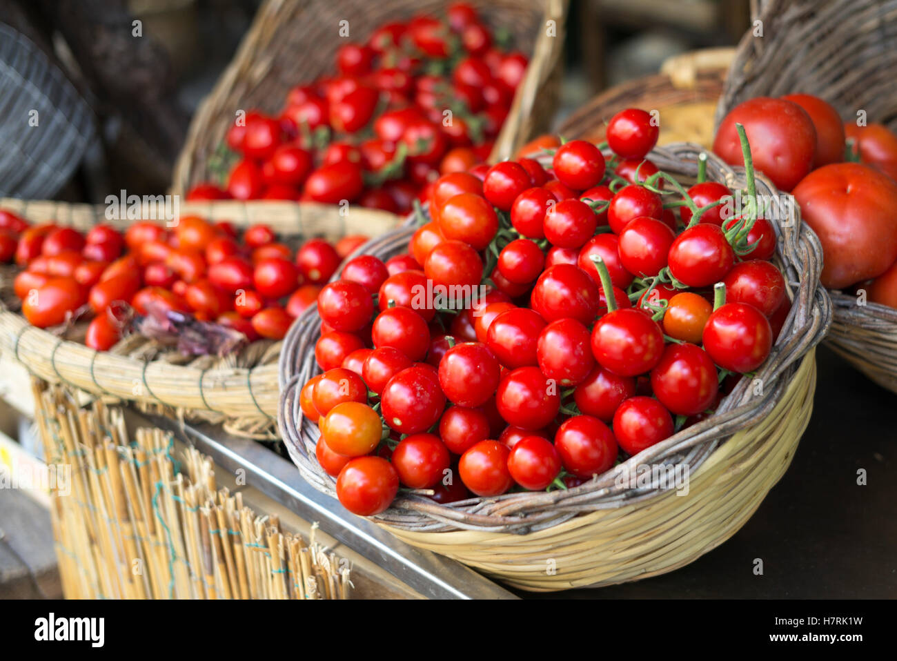 Bright red, ripe tomatoes in baskets; Ischia, Campania, Italy Stock Photo