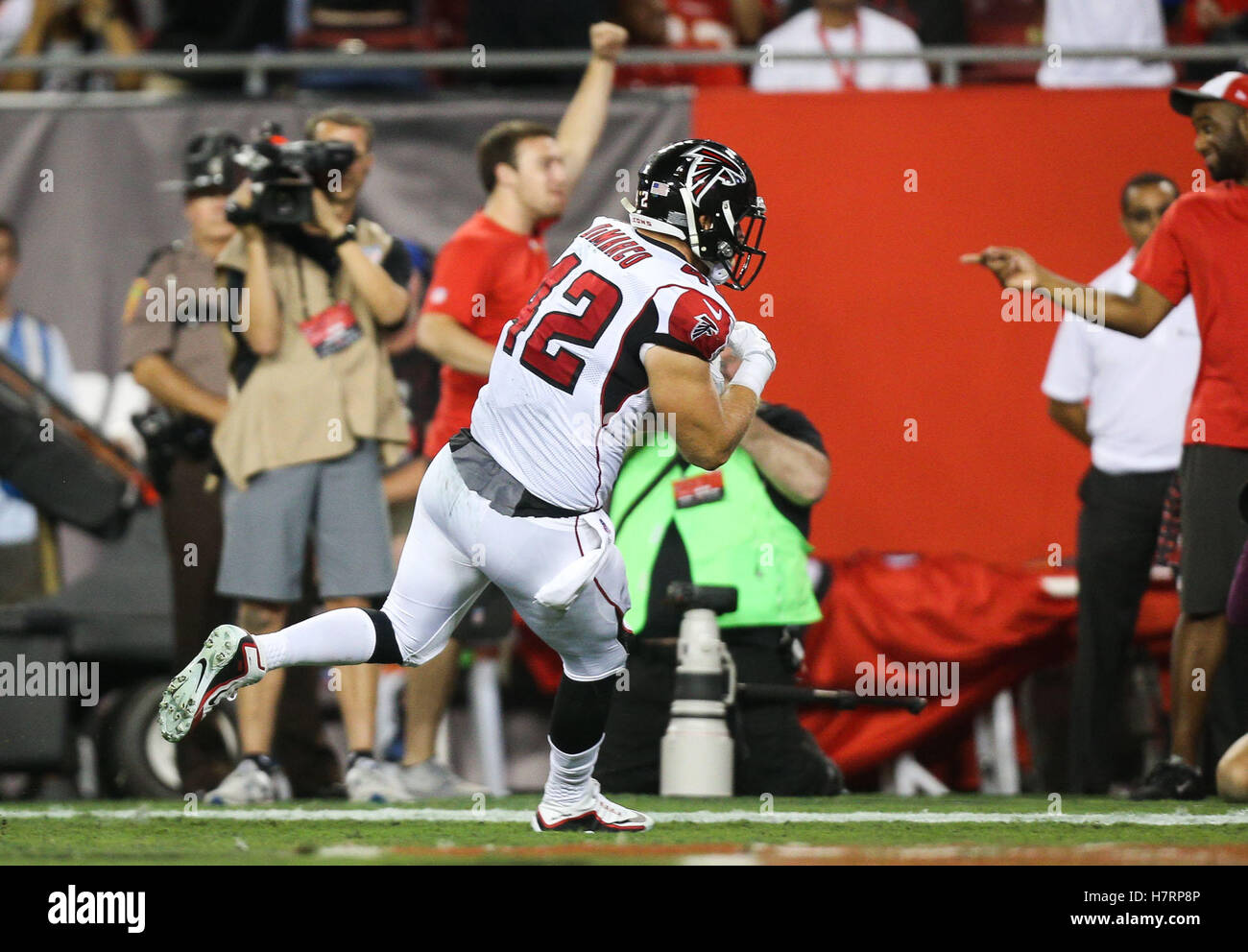 San Francisco 49ers nose tackle Isaac Sopoaga (90) makes a diving tackle on  Atlanta Falcons fullback Jason Snelling (44) during the second half of the NFC  Championship game at the Georgia Dome