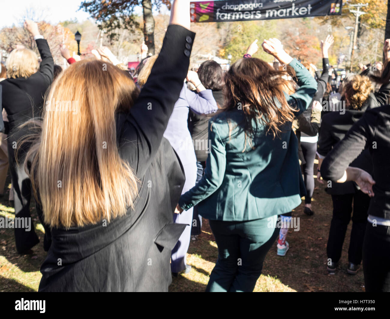 Chappaqua, NY, USA - 8 November 2016. Members of a Pantsuit Up flash mob dancing in presidential candidate Secretary of State Hillary Clinton's home town of Chappaqua, New York at the Chappaqua Train Station on Election Day. Credit:  Marianne A. Campolongo/Alamy Live News Stock Photo