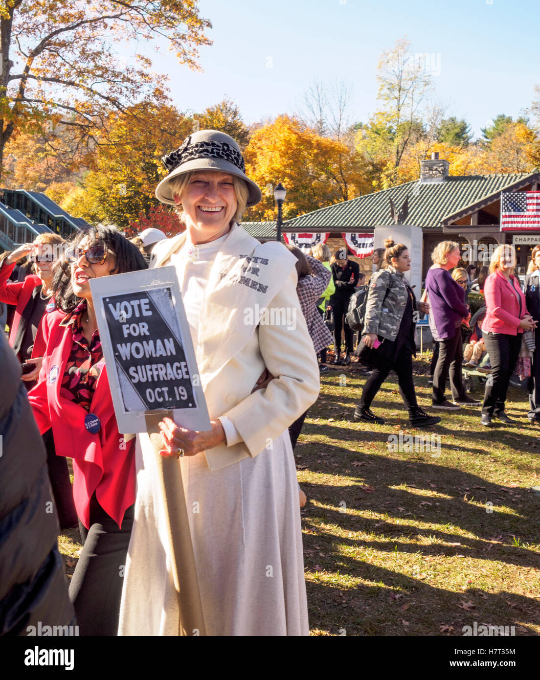 Chappaqua, NY, USA - 8 November 2016. Mary Refling of Chappaqua New York dressed as a suffragette in support of Hillary Clinton as gather in presidential candidate Secretary of State Clinton's home town of Chappaqua, New York for a Pantsuit Up flash mob at the Chappaqua Train Station on Election Day. Credit:  Marianne A. Campolongo/Alamy Live News Stock Photo
