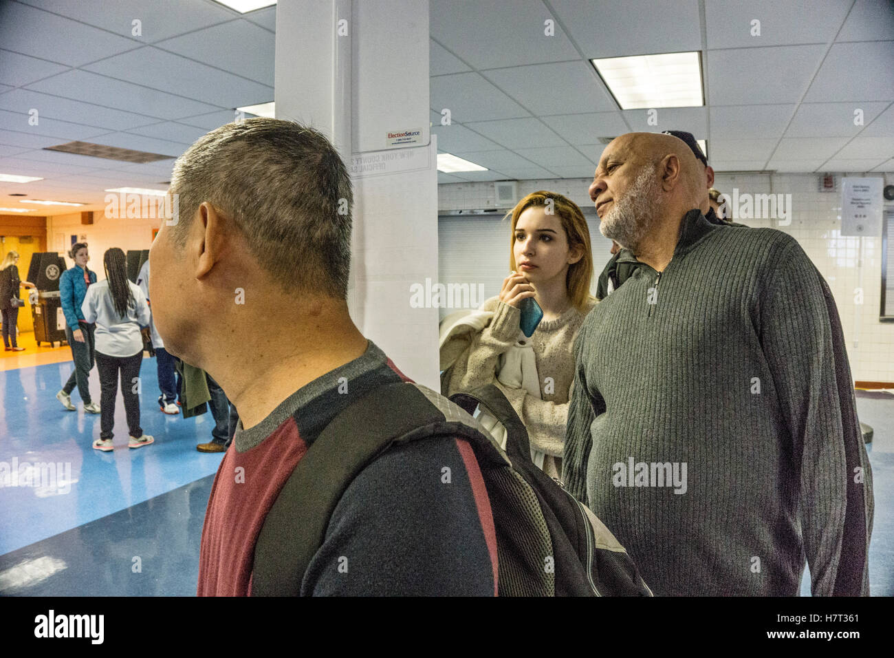 New York, USA. 8th November, 2016. New Yorkers in line for ID, signature & ballot pick up at Park West Vocational High School in Hells Kitchen neighborhood. In the background other voters receive instruction in scanning ballots. Park West High School gathers teens from many boroughs to train as cooks. Credit:  Dorothy Alexander/Alamy Live News Stock Photo