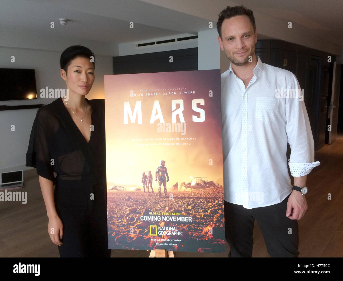 London, UK. 19th Oct, 2016. The main actors of the six-episode TV series 'MARS' of the National Geographic Channel, Ben Cotton (R) and Jihae (L) pose next to a poster in London, England, 19 October 2016. Cotton plays the character of commander Ben Sawyer, while Jihae portrays the twins Hana and Joon Seung. Photo: Katrin Kasper/dpa/Alamy Live News Stock Photo