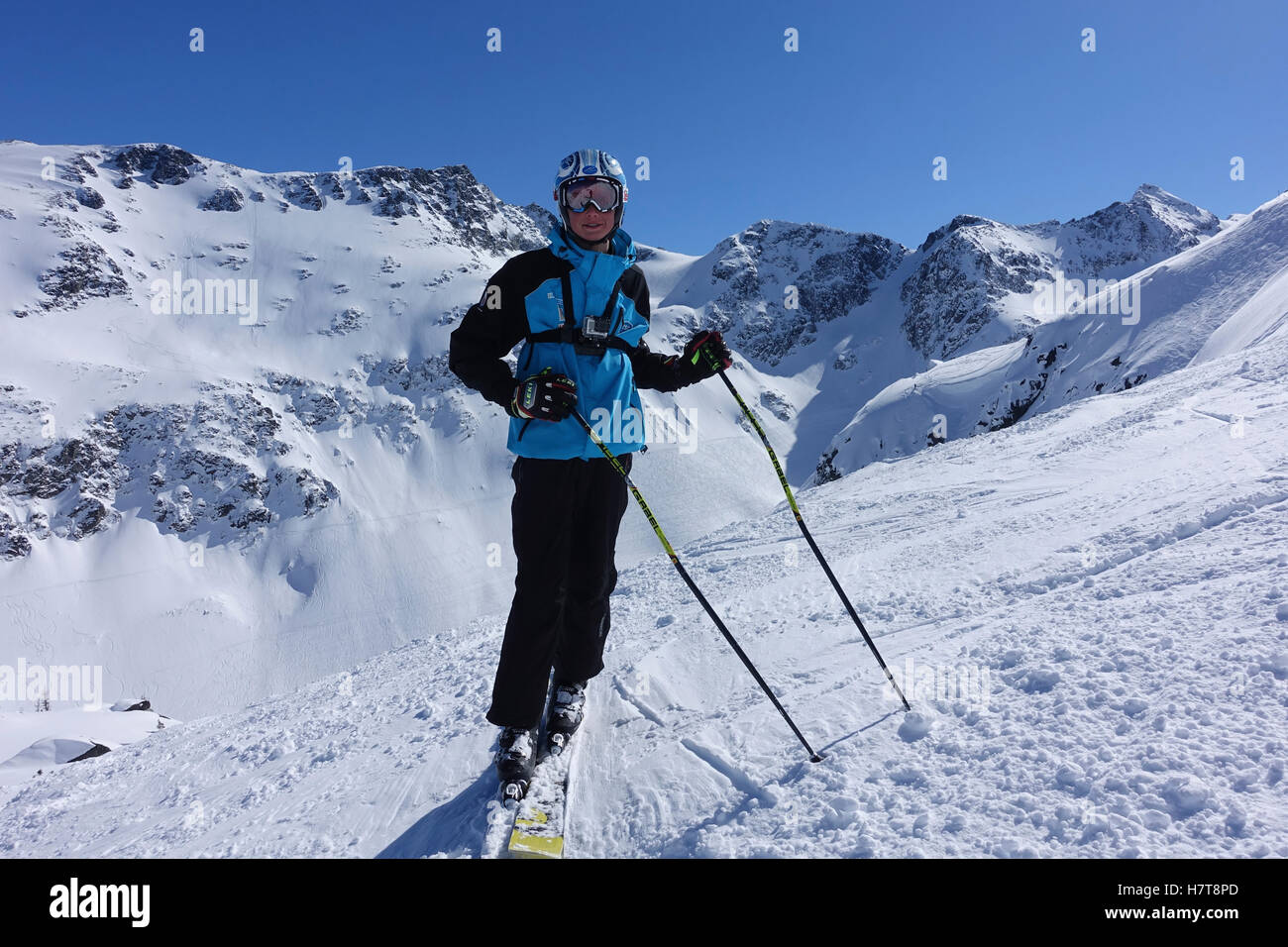 Skier against Blackcomb Gemstone Bowls; Whistler, British Columbia, Canada Stock Photo