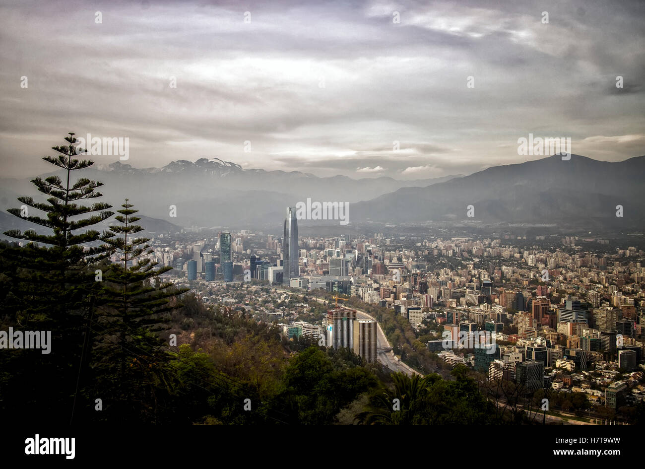 Skyline view of Chile's capital city Santiago against a backdrop of the Andes Mountains from above. Stock Photo
