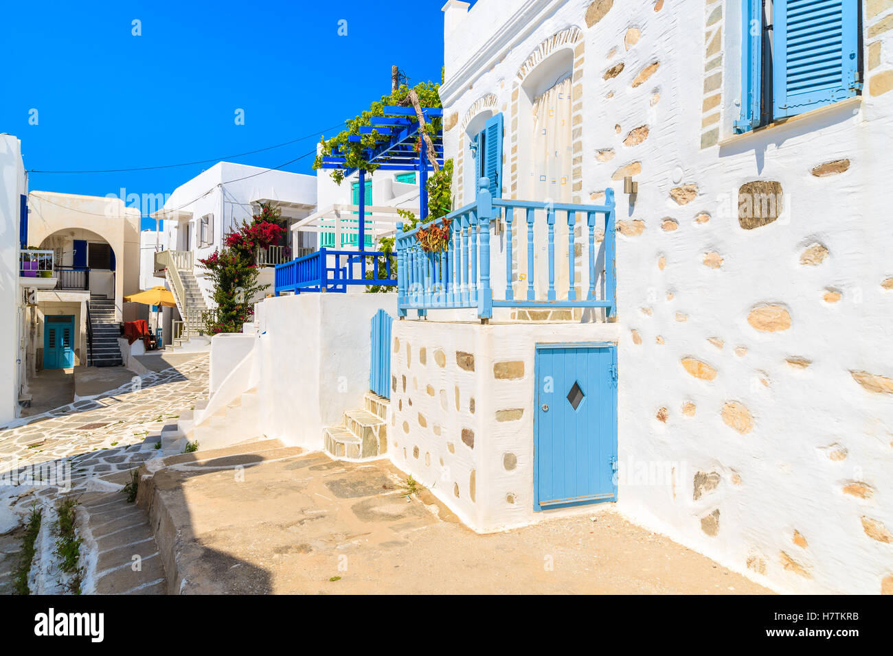 Street with traditional white Greek houses in Naoussa town, Paros ...