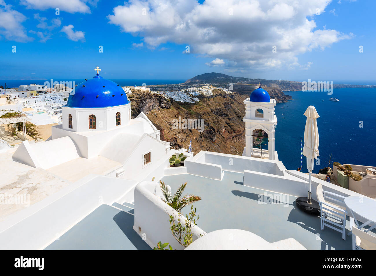 Blue dome of church in Imerovigli village and view of blue sea with caldera on Santorini island, Greece Stock Photo