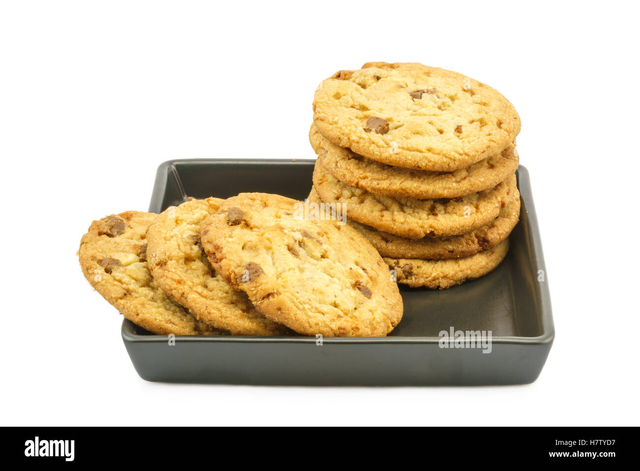 Almond chocolate cookies in black plate on white background Stock Photo