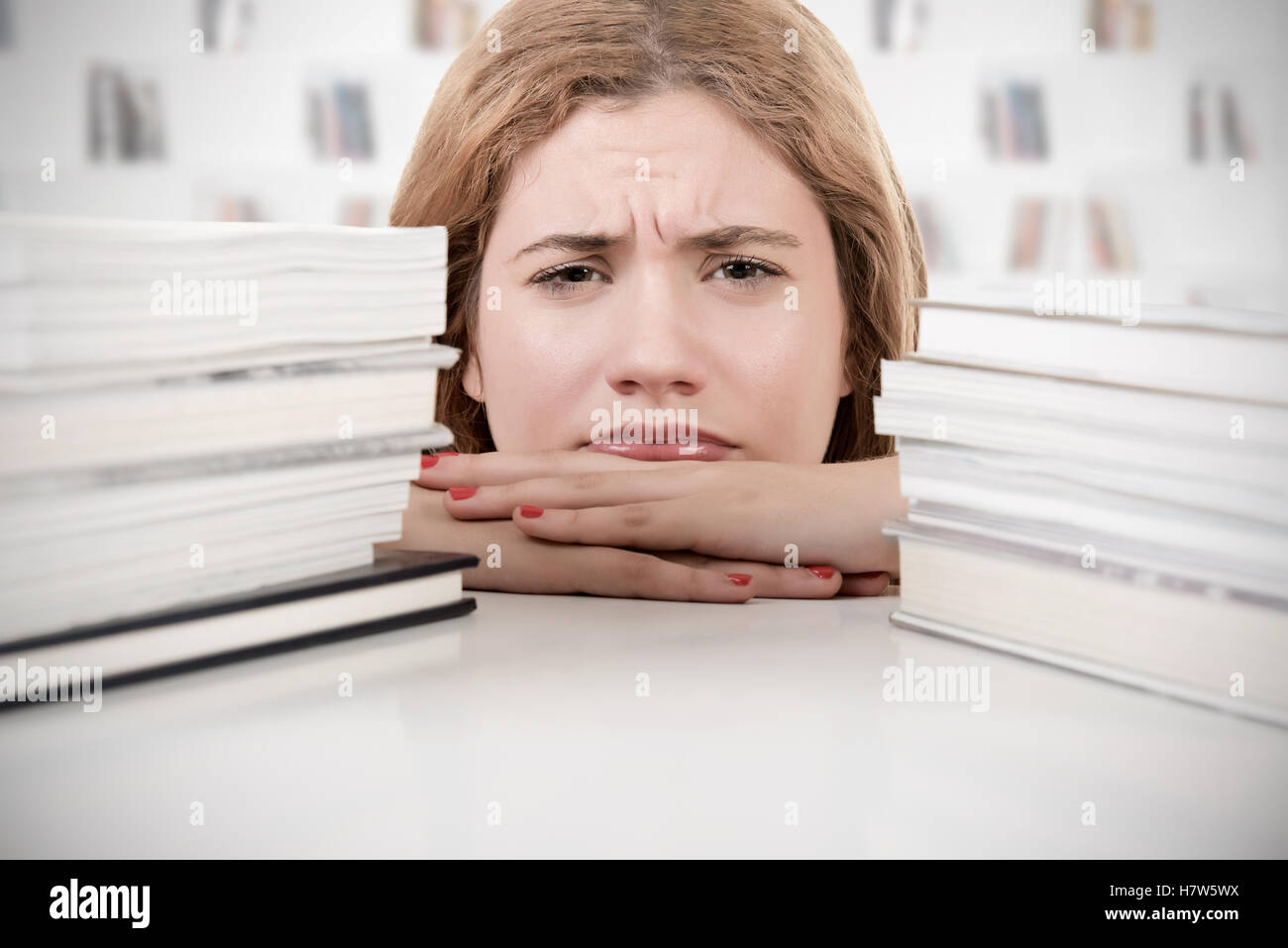 Young woman tired of studying hard for her exams Stock Photo