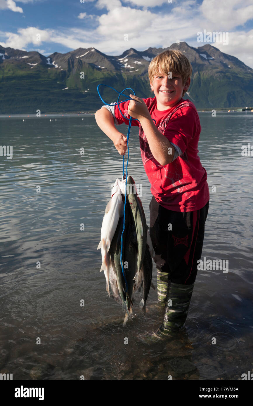 Young boy holds up a stringer of Pink salmon caught from the ocean
