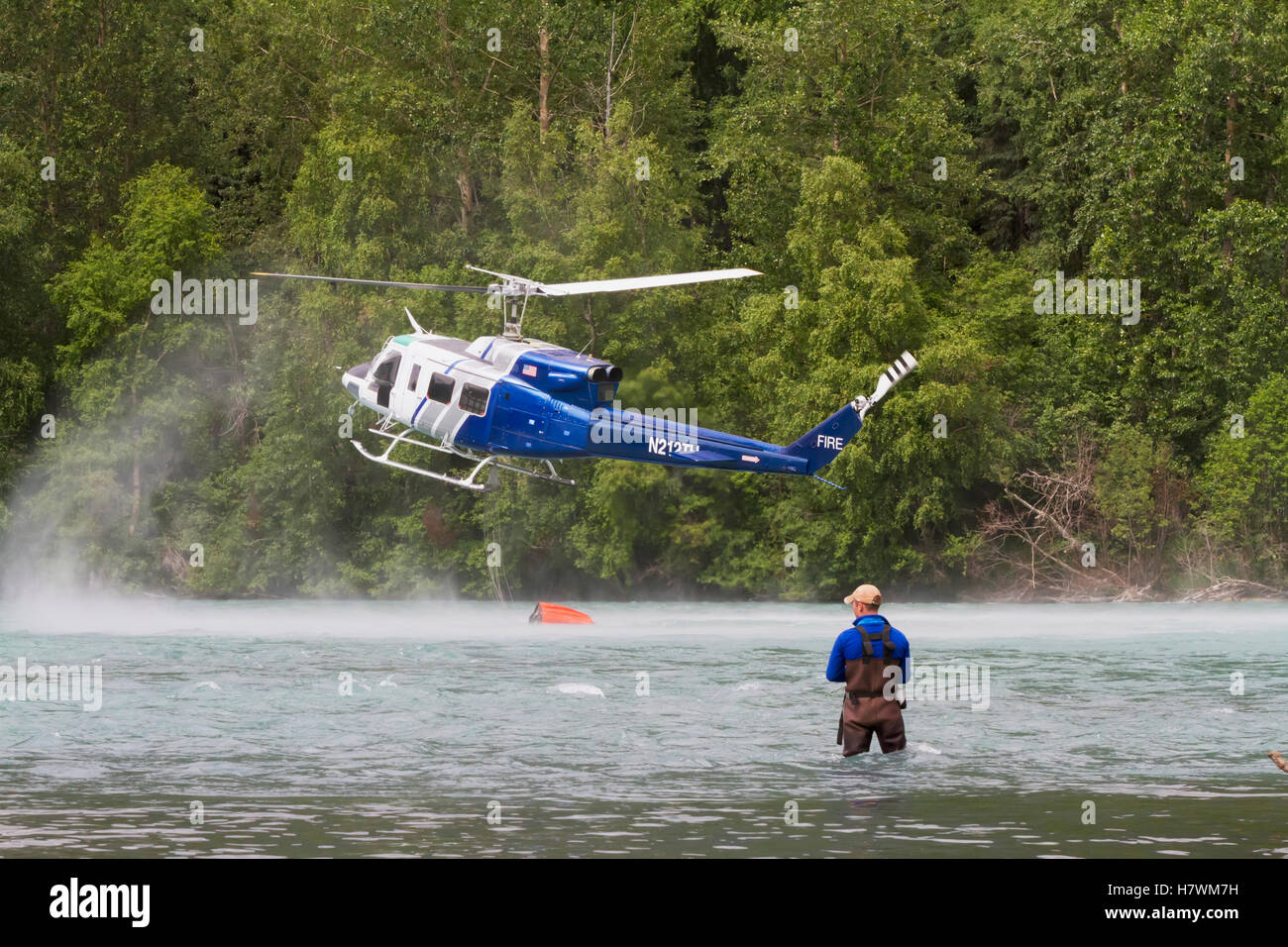 Helicopter crew puts out small fire near the confluence of the Kenai River and the Russian River, Kenai Peninsula, Southcentral Alaska, USA Stock Photo