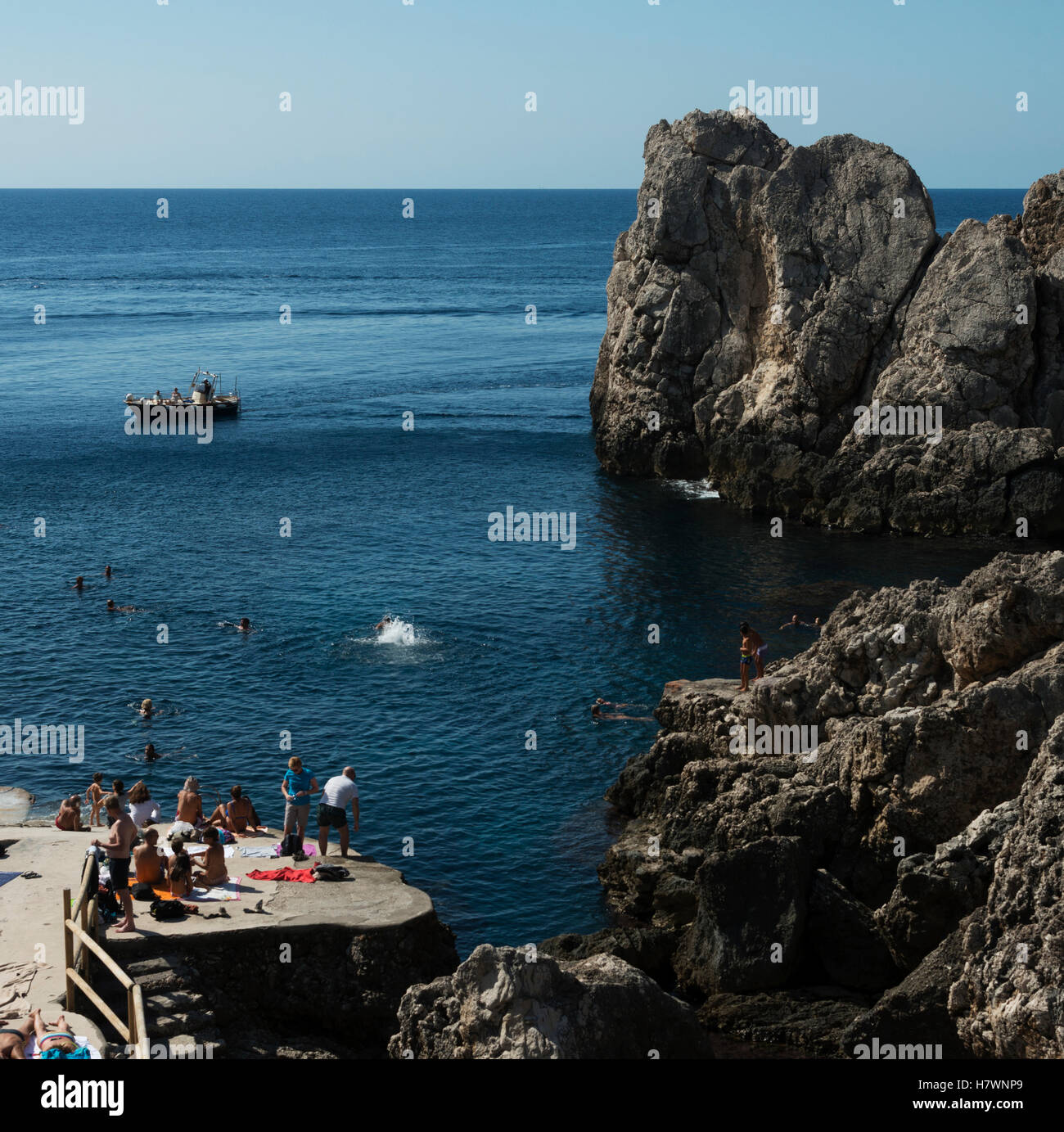 Swimming and sunbathing along the rugged coast of the island of Capri; Capri, Campania, Italy Stock Photo